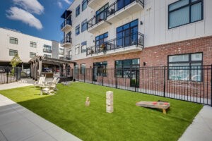 View of the lawn area with corn hole boards at City South multifamily apartment complex in Knoxville, TN